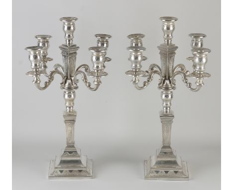 Two capital silver candlesticks, 925/000, 5 lights, on a square foot with garland decoration and pearl rims.&nbsp;The 4 arms 