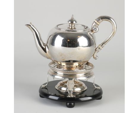 Silver teapot with stove, 833/000.&nbsp;Sphere teapot with pearl rim, size: L.Spiegeler Amsterdam, jl.: D:1873, placed on a s