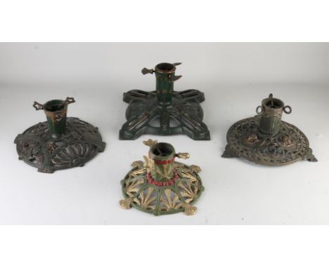 Four antique polychrome iron Christmas tree stands.&nbsp;First half 20th century.&nbsp;Dimensions: 25 - 30 cm.&nbsp;In good c