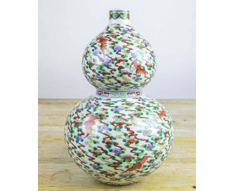 CHINESE DOUBLE GOURD VASE, Qianlong style, doucai decorated with repeat multi coloured enamel pattrn and bats, 30cm H. 