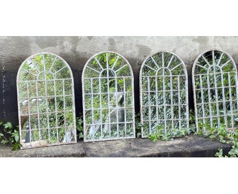 ARCHITECTURAL GARDEN MIRRORS, a set of 4, arched top aged metal frames, 60cm x 36cm. 