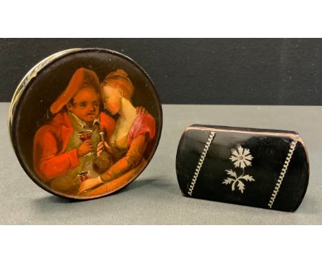 A 19th century circular lacquered papier mache painted snuff box, lid painted with figures drinking wine, 10cm diameter;  ano