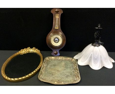 A gilt oval mirror, ribbon tied cresting, 63cm high;  an oak barometer;  a 'Persian' brass tray;  a ceiling light (4) 
