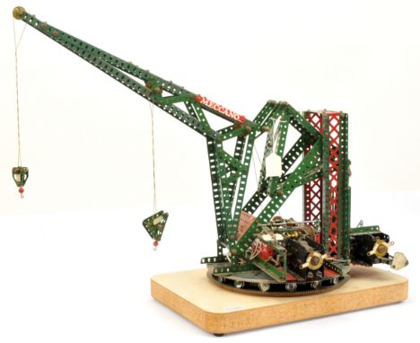 Meccano model of a Luffing Crane in red and green parts, electrically driven, featuring raising and lowering crane hooks, luf