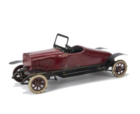 A Structo No 10 Automobile,  red painted steel, fixed keywind mechanism with brake, windshield and spoked wheels with white t
