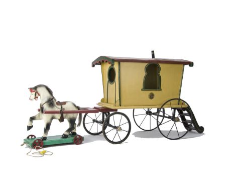 A large G & J Lines Wooden Horse-Drawn Gypsy Caravan,  repainted yellow with green and yellow detail, brown roof with chimney