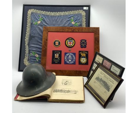  Framed square silk panel with coat of arms 50cm, frame containing nine LNER luggage labels, military tin helmet etc   - Cond