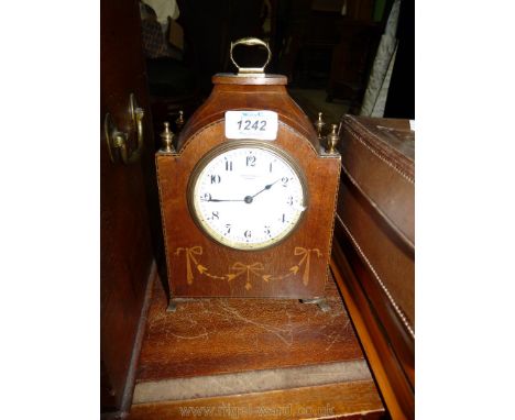 A wooden cased Mantle clock by Conroy Couch, Torquay, with Arabic numerals, key in back, feet loose, 9 1/4" tall and a lightw