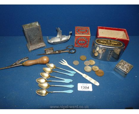 Six enamel handled teaspoons, metal matchbox holder, wick scissors, a small alphabet biscuit tin etc