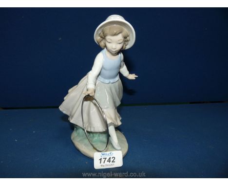 A Nao figure of a girl with a hoop, 8'' tall.