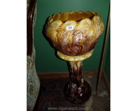 A William Ault art pottery Jardiniere on stand in the Oceana pattern, relief decorated with fish, the stand with crabs and tu