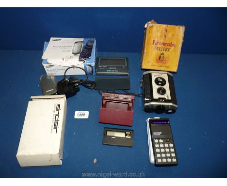 A Brownie Reflex camera, Sinclair Cambridge Electronic calculator, Oregon Scientific Hi-Glo Night Finder, Samsung Clamshell G