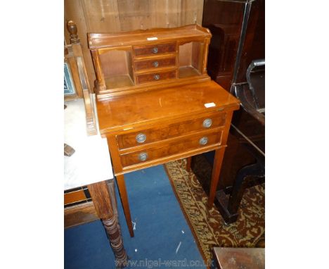 A Yew wood finished Escritoire/Lady's writing Desk having an upstand with two pigeon holes and three central drawers, the bas