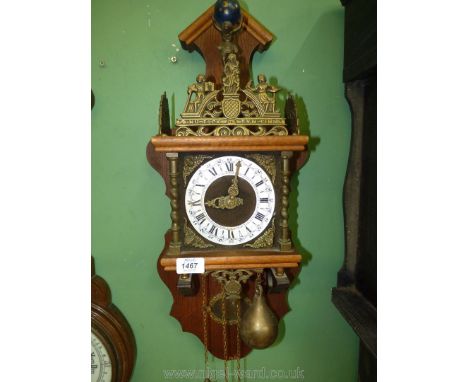 An unusual Wall Clock having a farmed of Oak and other woods, the movement driven by heavy pear-shaped metal weights having a