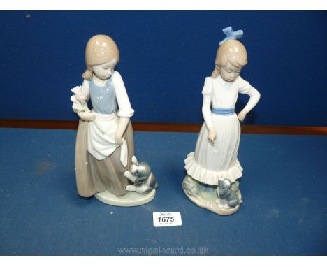 Two Nao figures of a girl with blue ribbon in her hair with a puppy at her feet (thumb missing), 10 3/4'' tall and a girl wit