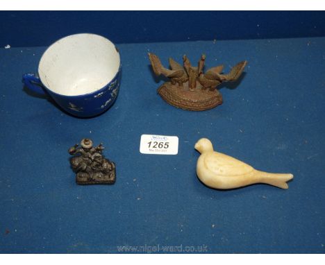 Oriental collectibles including a rare Chinese enamel export tea cup, 18th c., an Indian alabaster carving of a dove, 17th c.