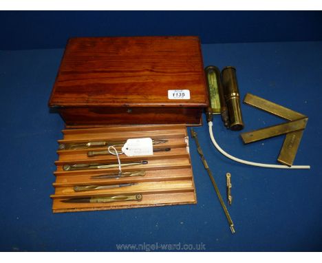 A wooden box and contents including brass mining engineering tools, instructions for Otis Kings Calculator, pocket draught ga