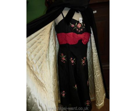 A vintage black cocktail dress with pink bow and embroidered blossom with matching black velvet cloak.