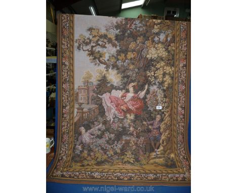 A tapestry wall hanging of a gentleman pushing a lady on a swing, 33'' high x 35'' wide.