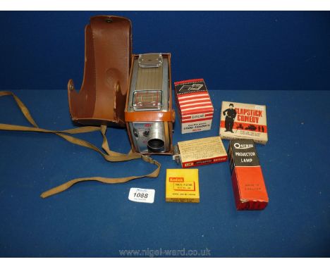 A cased Brownie 6mm movie camera, double glass slide binders, projector lamp, Haze filter size no. 250  and a slapstick comed