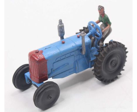 Crescent Toys modern farm equipment No. 1805 tractor and driver, comprising of blue and red body with black rubber tyres and 