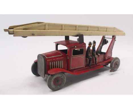 A tinplate and clockwork Mettoy fire engine comprising red body with cream extending ladder, Dunlop balloon tyres, complete w