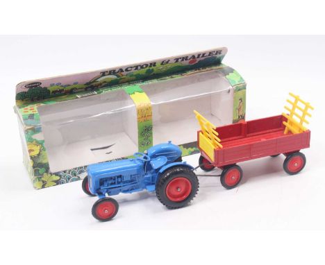 Crescent No.1811 Tractor in blue body with red hubs together with a Red Trailer with red hubs, both housed in plastic window 
