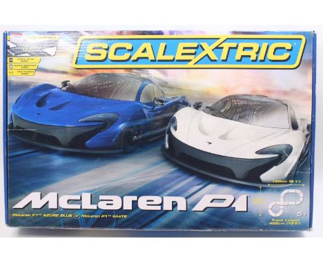 Scalextric Mclaren P1 set, comprising two Mclaren P1 cars, two extra F1 cars, a crossover, power supply, and controllers, tog