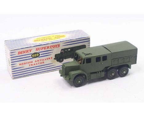 Dinky Toys No. 689 Medium Artillery Tractor, military green body with green tin rear canopy, seated drive figure with green h