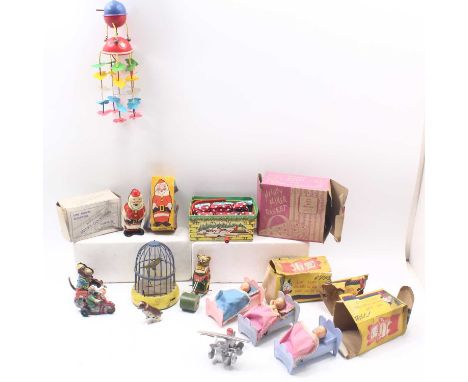 A collection of playworn tinplate clockwork toys to include a Wells Police radio motorcycle, a German-made jumping dog, a Hof