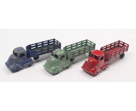 A collection of three various Louis Marx articulated tractor units and open trailers, one example red, the other green and bl