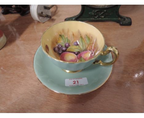An Aynsley cup and saucer duck egg green with gilt and fruit design