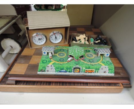 Two modern Chess boards and one set of Chess pieces, a time clock and a European tinplate clockwork toy