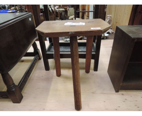 A traditional oak three legged milking stool