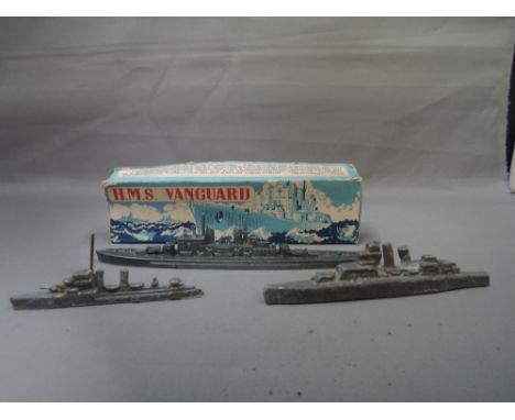 A Crescent Toys grey cast model, HMS Vanguard, boxed and two similar grey cast model battleships