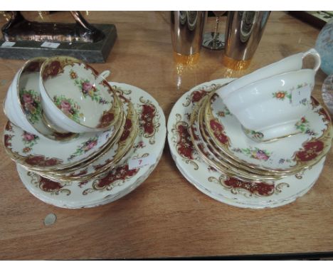 A part Grosvener tea service foliated in gilt and burgundy with floral pattern