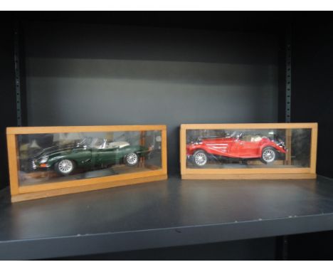 Two Burago 1/18th scale die-casts, Mercedes Benz 500 and Jaguar E Type, both in display cases