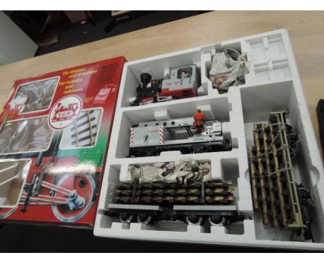 An LGB G scale starter set comprising 0-4-0 locomotive, two railroad trailer, crane trailer and control unit, boxed