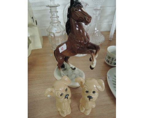 Three ceramic figurines including a rearing horse is Beswick style and two dogs