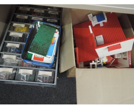 A shelf of 1970's and later Lego pieces and magazines