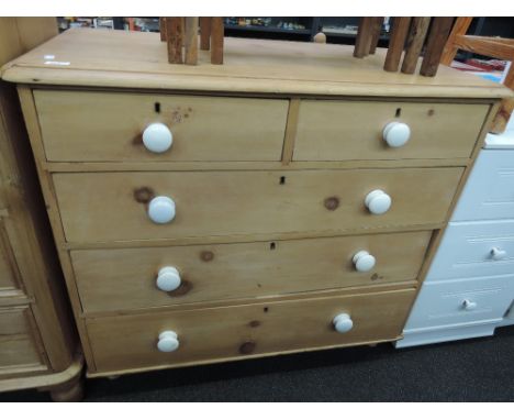 A 19th Century stripped and refurbished pine two over three drawer chest having ceramic handles