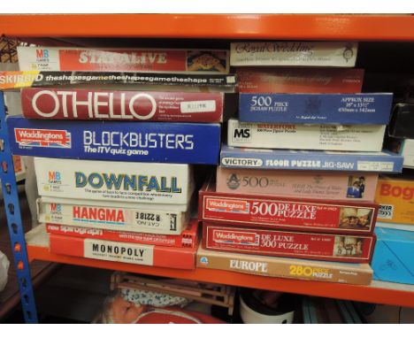 A shelf of 1980's and later games and jigsaws including Operation, Downfall, Guess Who etc