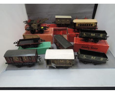 Eleven Hornby O gauge tinplate carriages and wagons, most in original boxes