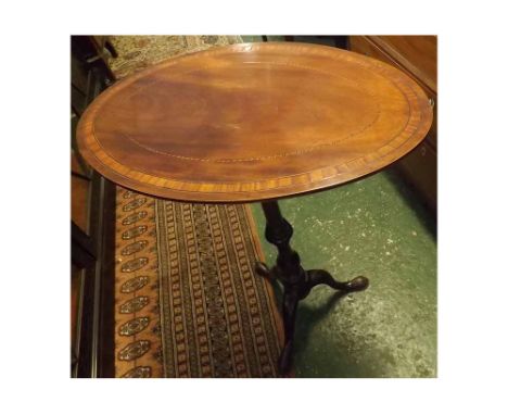 19th century mahogany and inlaid wine table, the oval top over a turned column and tripod base  