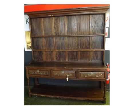 Large 19th century oak dresser, with two shelf back over a base with three short drawers and pot board shelf, raised on turne