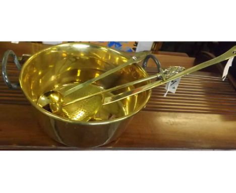 19th century brass circular pan with iron handles together with a brass skimmer, brass ladle and further brass mounted brush 