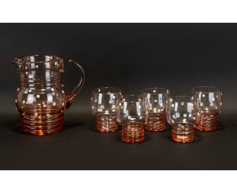 Mid 20th Century Glass Lemonade Pitcher &amp; Beakers.  Pale rose-tone shaped glass pitcher with ridge base and neck with cre