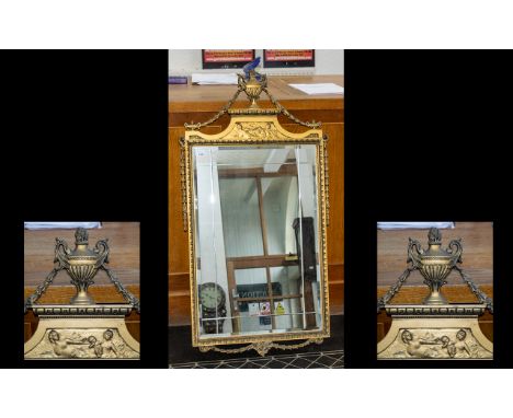 Mid 20thC Gilt Framed Mirror with bevelled glass and decorated with an Urn finial in the Adam's Style. Measuring 45 by 22 inc