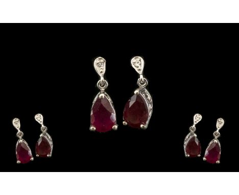 Ruby Pear Drop Earrings, each earring having a pear cut solitaire of 1.75cts, suspended below round cut white zircons set in 