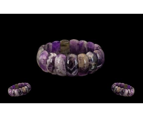 Sage Amethyst Bracelet, a bangle style bracelet comprising domed panels of amethyst in a wide variety of shades of purple, in